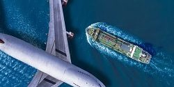 Aerial top view, Passenger plane flying over oil tanker sailing is high speed on the sea.